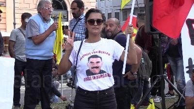 Scene from Curdi, manifestanti mettono in scena la lotta contro Isis: falò dei simboli del Daesh