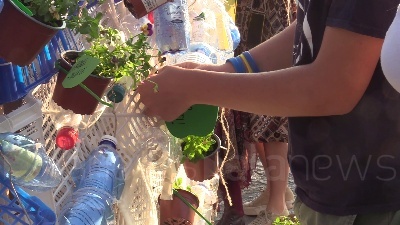 Scene from Clima, azione di Fridays For Future Milano: una balena di piantine e bottiglie in piazza XXIV maggio